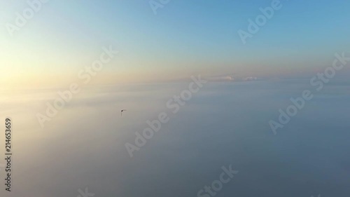 Flight over the clouds at dawn.