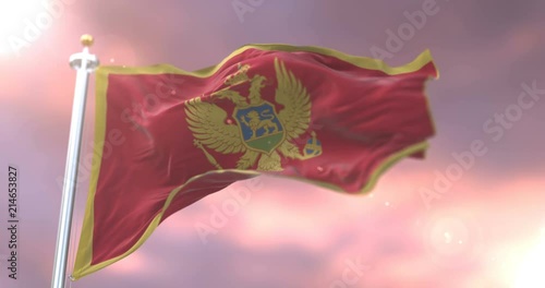 Flag of Montenegro waving at wind at sunset in slow, loop photo
