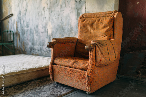 Drug addict room, grunge armchair and mattress photo