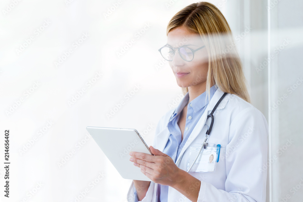 Female doctor working with laptop and researching some medication information in the consultation. Female doctor working with laptop and researching some medication information in the consultation.
