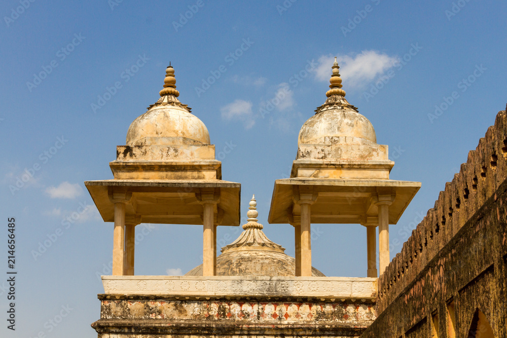 White towers on the fortress of Jaipur before a blue sky
