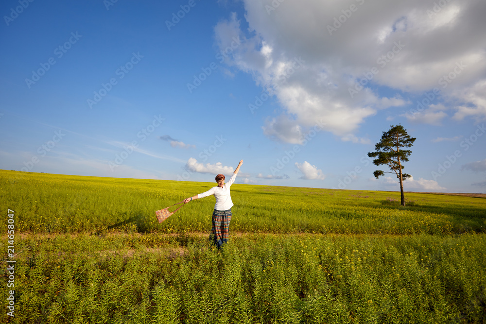 A young woman is playing on a flowering meadow. Enjoy life A young woman is playing on a flowering meadow. Enjoy life