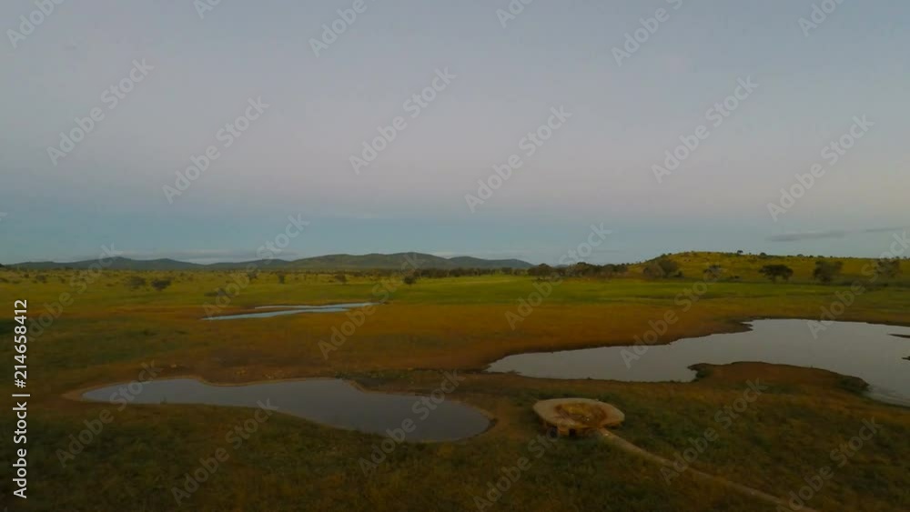 water hole in kenyas savanna in the afternoon water hole in kenyas savanna in the afternoon