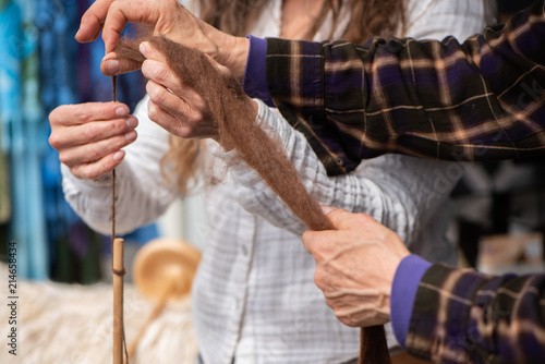 Women spinning yarn from Alpaca fiber at the farmers market