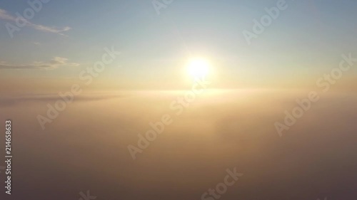 Flight over the clouds at dawn.
