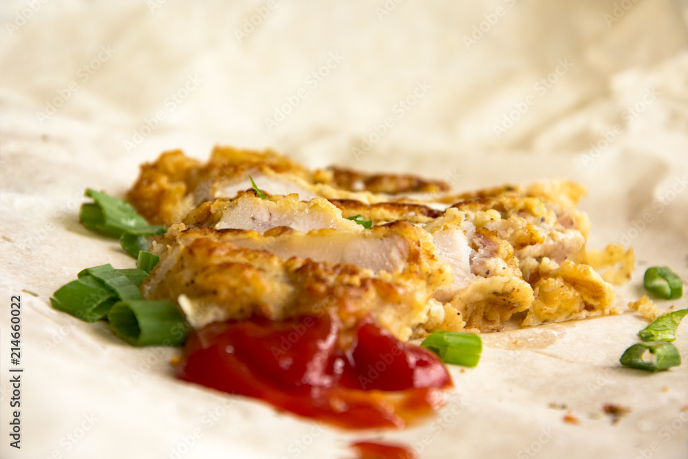 Fresh fried pork chops sprinkled with green onions and ketchup. Arrangement on the wrapping paper Fresh fried pork chops sprinkled with green onions and ketchup. Arrangement on the wrapping paper