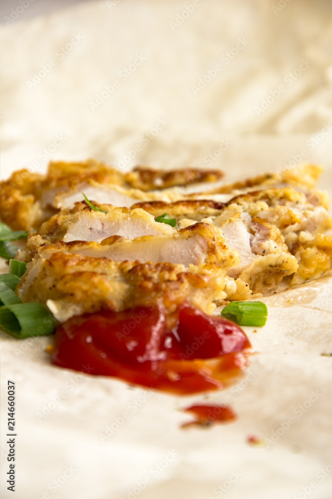 Fresh fried pork chops sprinkled with green onions and ketchup. Arrangement on the wrapping paper Fresh fried pork chops sprinkled with green onions and ketchup. Arrangement on the wrapping paper