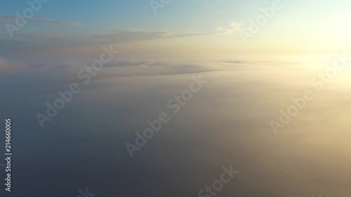 Flight over the clouds at dawn.
