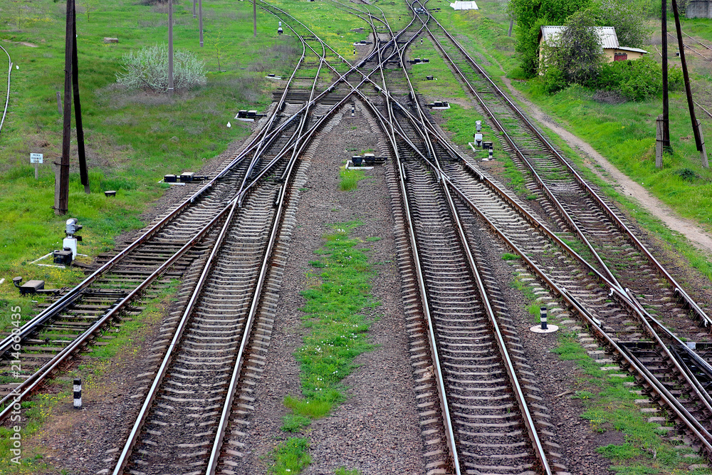 Obraz premium Railway, the top view on rails. Leading parallel steel rails with regular crossbars. Abstract geometric view.