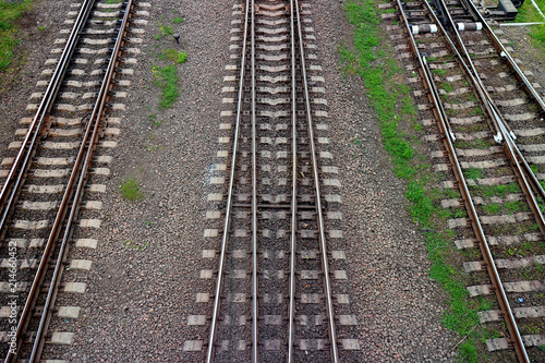 Railway, the top view on rails. Leading parallel steel rails with regular crossbars. Abstract geometric view.