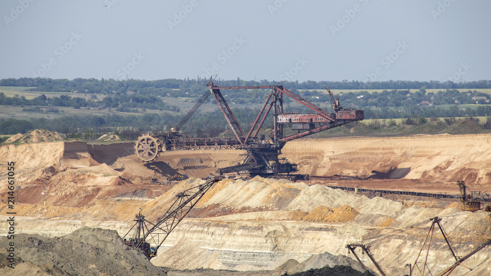The operating machines in the quarry for the extraction of manganese ore