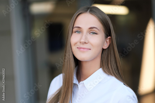 Portrait of a young beautiful girl in a business style outdoor.