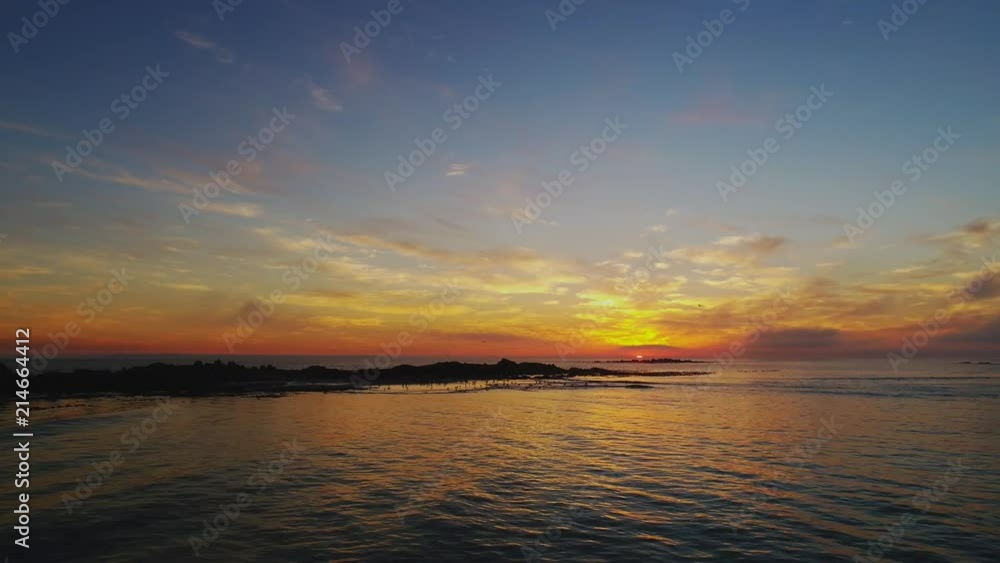 Timelapse tracking left over beach and island with seagulls during beautiful sunset at Bloubergstrand, Cape Town, South Africa Timelapse tracking left over beach and island with seagulls during beautiful sunset at Bloubergstrand, Cape Town, South Africa