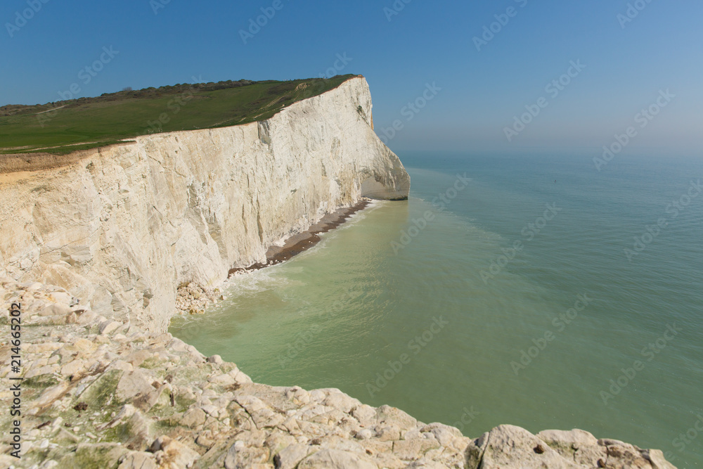 Beautiful English coast Seaford East Sussex England uk with white chalk cliffs, waves and blue sky