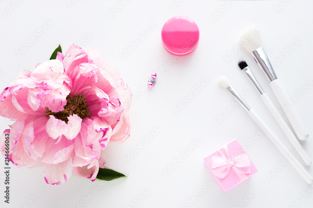 White background with copy space, pink peony flower, earrings, makeup brushes, small gift for girl, advertising space, top view White background with copy space, pink peony flower, earrings, makeup brushes, small gift for girl, advertising space, top view