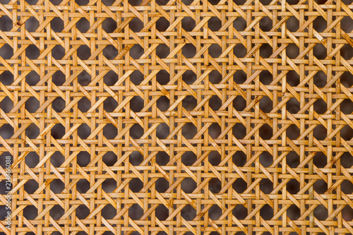 Close up of the pattern formed by open weave rattan cane photo
