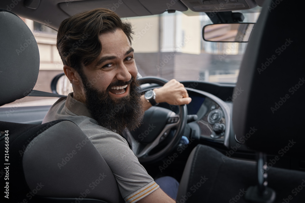 Happy charismatic man driving a car Happy charismatic man driving a car