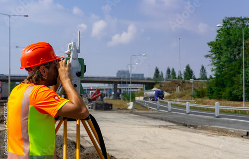 Surveyor, total positioning station on the site photo