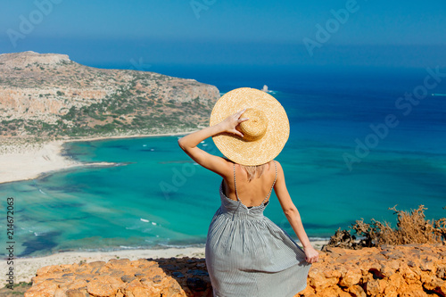 Obraz na plátně Young redhead girl in hat and dress with sea coastline on Balos, Crete, Greece