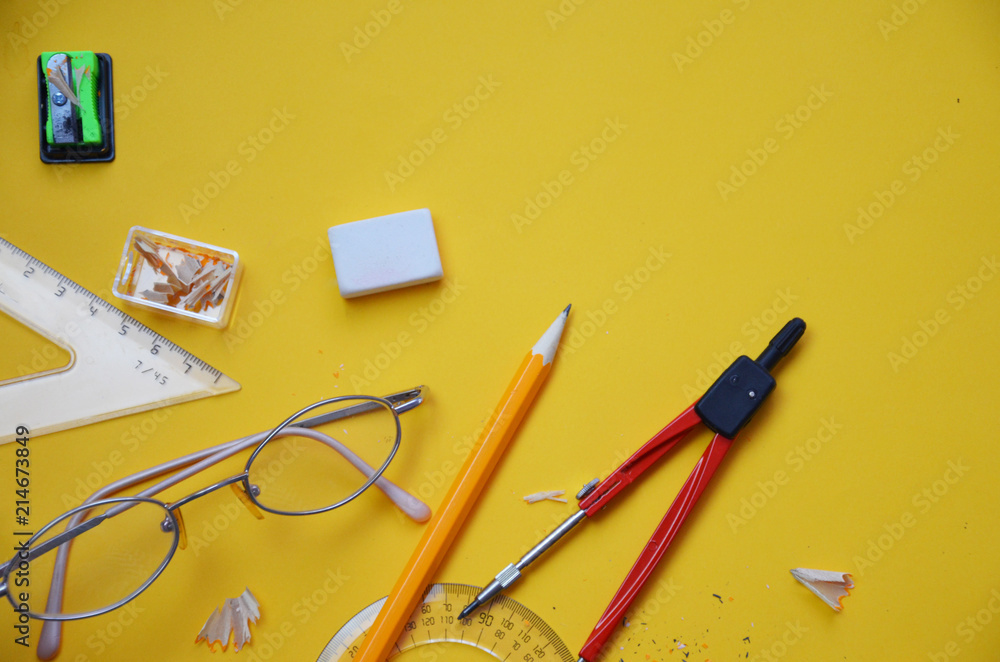 Back to school set in yellow. , notebook, pen, pencils, scissors, markers, chair, clip, glasses, compass, sharpener, eraser, autumn leaves Back to school set in yellow. , notebook, pen, pencils, scissors, markers, chair, clip, glasses, compass, sharpener, eraser, autumn leaves