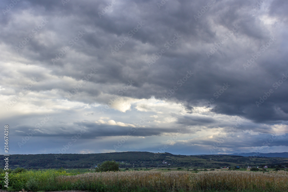 Stormy sky with clouds over the field Stormy sky with clouds over the field