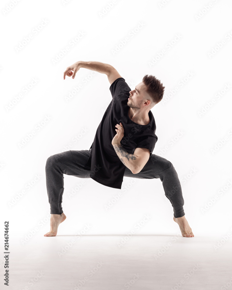 Young beautiful dancer is posing in studio