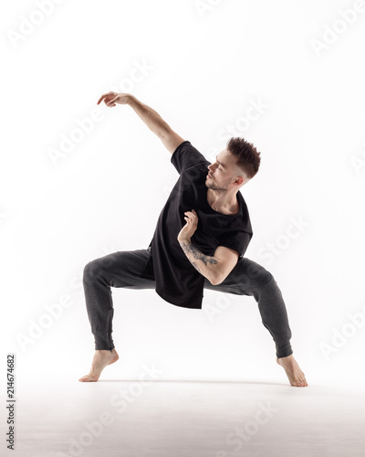 Young beautiful dancer is posing in studio