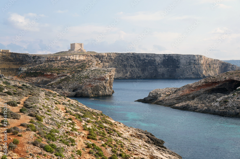 High cliffs and Santa Marija Tower on Commino Island in Malta (Torri ta' Kemmuna)