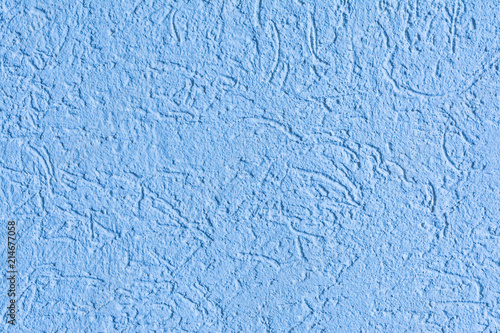 texture of the surface of the wall covered with decorative plaster of the woodworm type