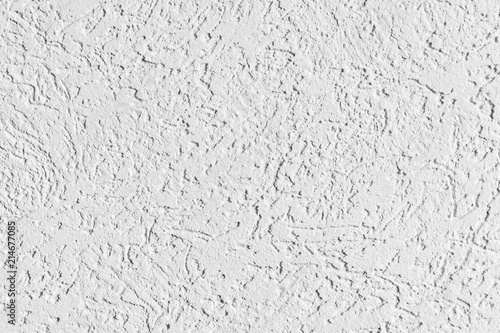 texture of the surface of the wall covered with decorative plaster of the woodworm type
