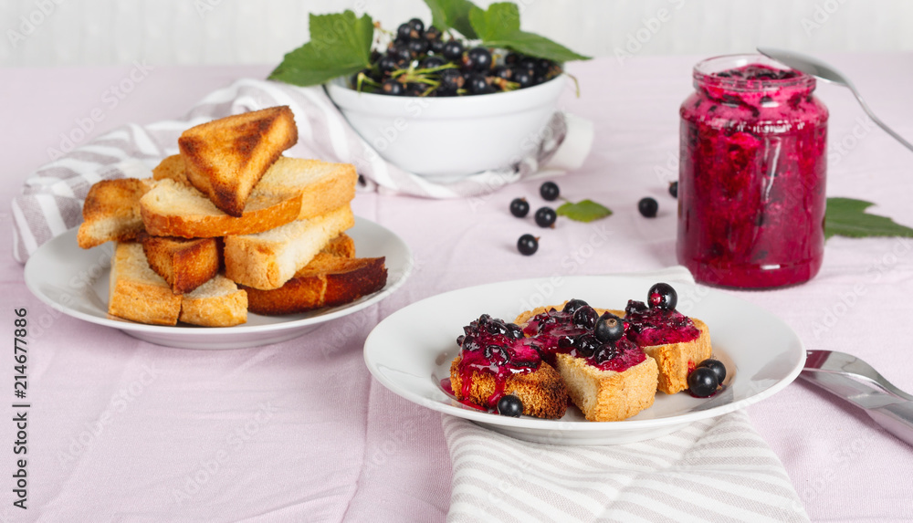 Delicious toasts bread with homemade currant jam with fork and knife Delicious toasts bread with homemade currant jam with fork and knife