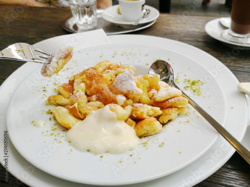 Woman eating Kaiserschmarren traditional Austrian and Southern German dessert dish