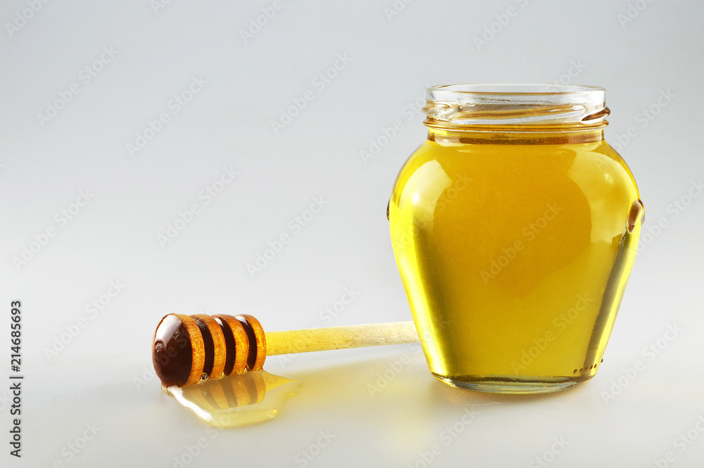 Honey jar with wooden honey dipper Honey jar with wooden honey dipper