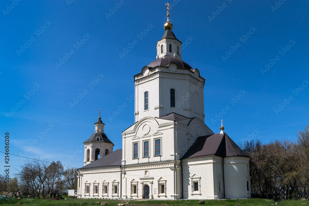 Ancient church with white walls against the blue sky