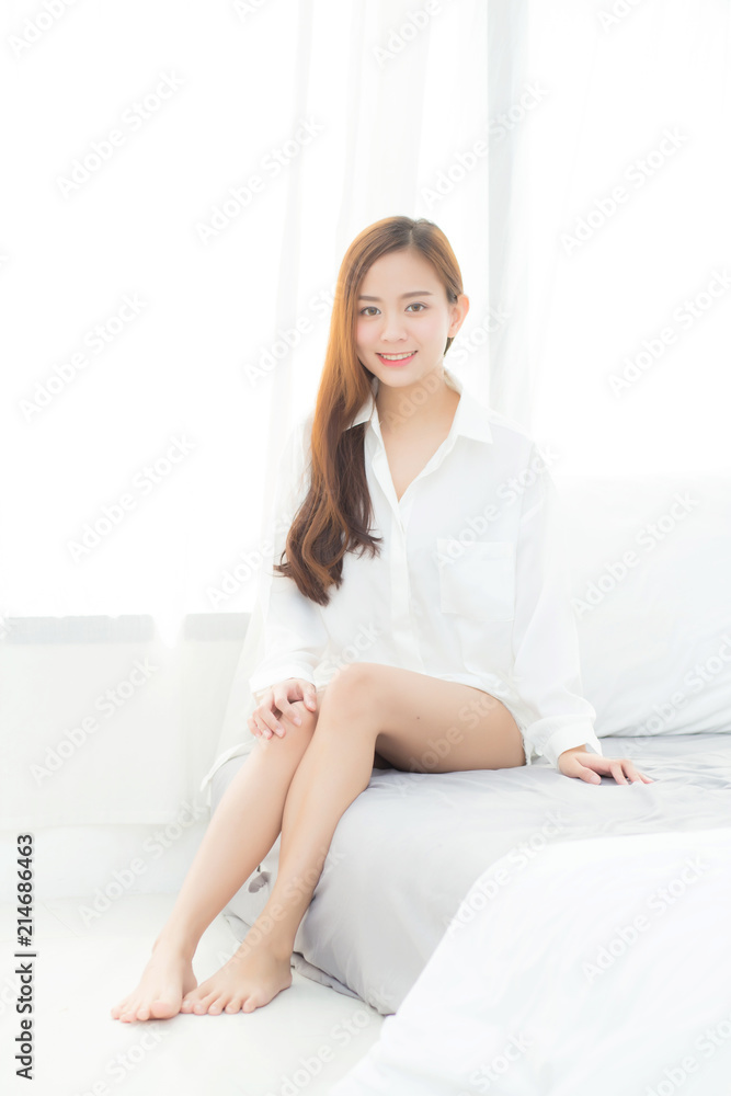 Portrait of beautiful young asian woman standing the window and smile while wake up with sunrise at morning, lifestyle and relax concept. Portrait of beautiful young asian woman standing the window and smile while wake up with sunrise at morning, lifestyle and relax concept.