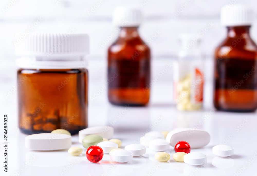 Capsules, pills and medical bottles on a white table. Capsules, pills and medical bottles on a white table.