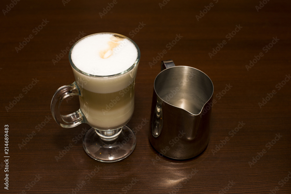 Coffee latte with creamer from above Coffee latte with creamer from above