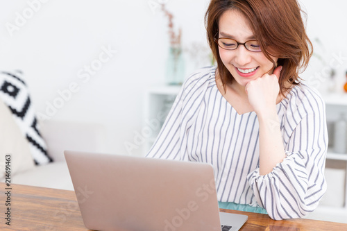 部屋でラップトップコンピュータを見る女性