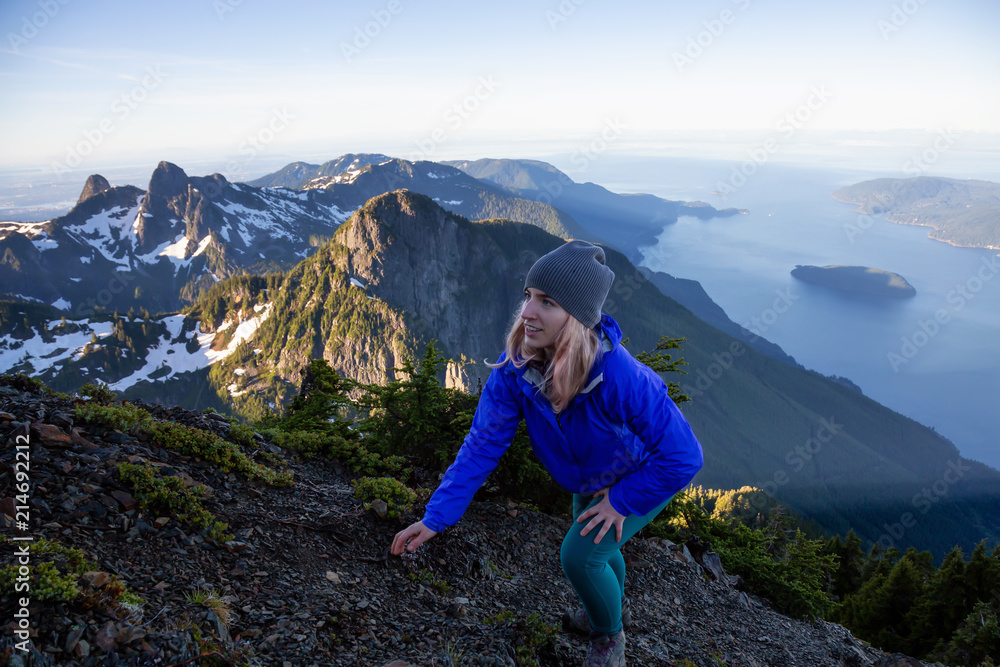 Adventurous woman hiking in the mountains during a sunny summer day. Taken on Mount Brunswick, Lions Bay, North of Vancouver, BC, Canada.