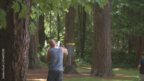 Slow-motion footage of a man attempting a shot in a game of frisbee golf and missing.  Shot on a Blackmagic Ursa Mini Pro 4.6k with a Sigma 50-100mm f/1.8. photo