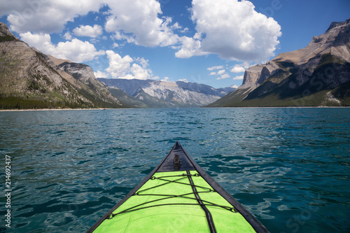 Kayaking in Lake Minnewanka during a vibrant sunny summer day. Taken in Banff, Alberta, Canada. © edb3_16