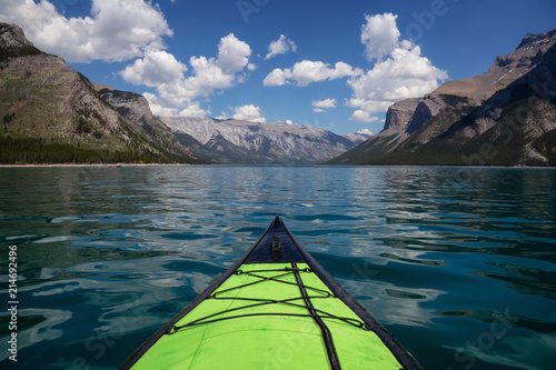 Kayaking in Lake Minnewanka during a vibrant sunny summer day. Taken in Banff, Alberta, Canada. © edb3_16