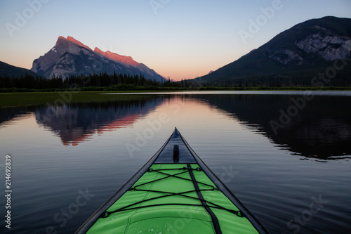 Kayaking in a beautiful lake surrounded by the Canadian Mountain Landscape. Taken in Vermilion Lakes, Banff, Alberta, Canada.