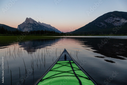 Kayaking in a beautiful lake surrounded by the Canadian Mountain Landscape. Taken in Vermilion Lakes, Banff, Alberta, Canada. © edb3_16