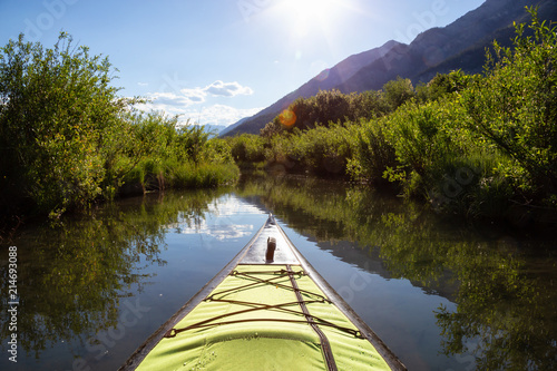 Kayaking in a beautiful lake surrounded by the Canadian Nature Landscape. Taken in Vermilion Lakes, Banff, Alberta, Canada.