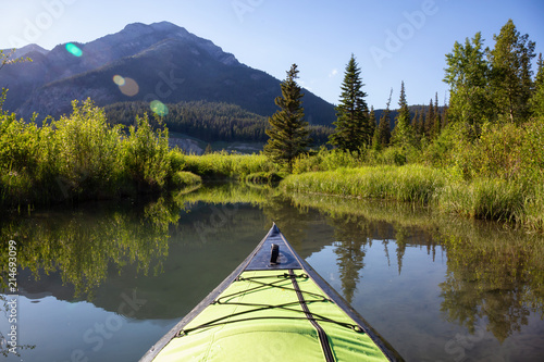 Kayaking in a beautiful lake surrounded by the Canadian Nature Landscape. Taken in Vermilion Lakes, Banff, Alberta, Canada. © edb3_16