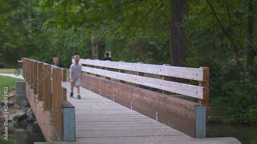 Slow-motion footage of brothers playing while running across a footbridge.  Shot on a Blackmagic Ursa Mini Pro 4.6k with a Sigma 50-100mm f/1.8. photo