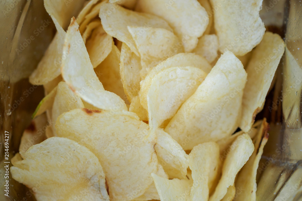 Potato chips in open snack bag close up