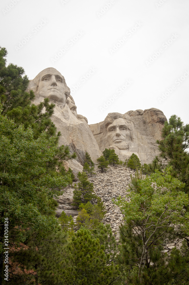 George Washington and Abraham Lincoln at Mount Rushmore Against a White Sky Background