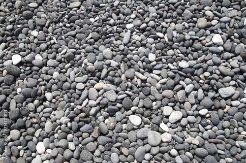 Gray and black pebbles on beach